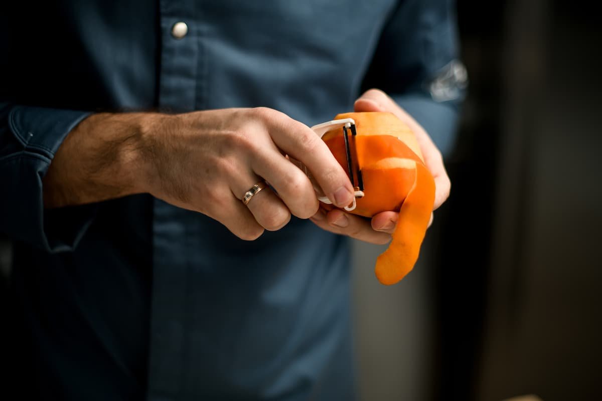 Man peeling an orange.jpg